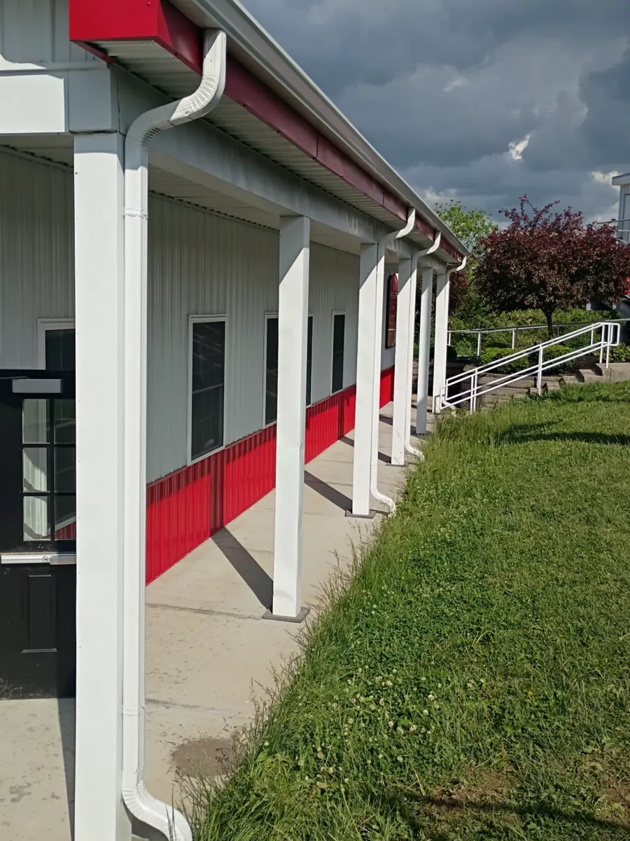 Detail of a seamless gutter and downspout under the eave